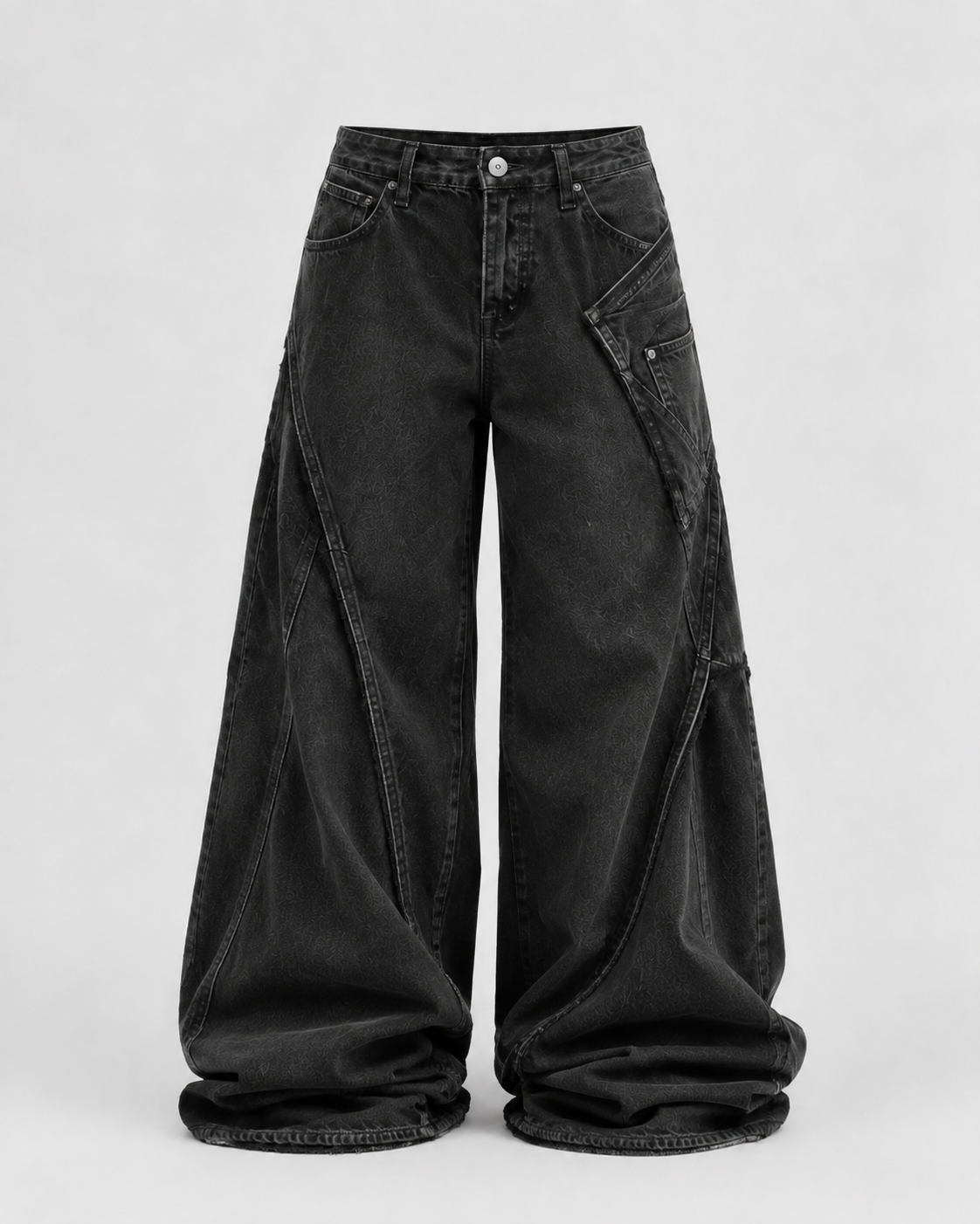 Extremely baggy charcoal jeans with curved leg panels, displaced pockets and long pooled hems