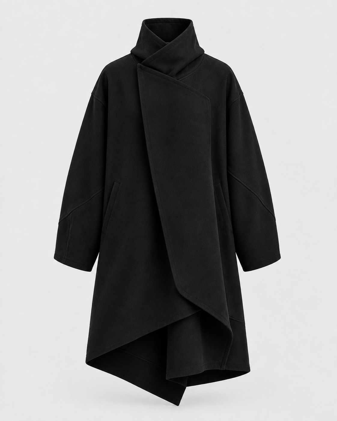 Long black coat with generous shoulders, an asymmetric wrap front and a sculptural irregular hem
